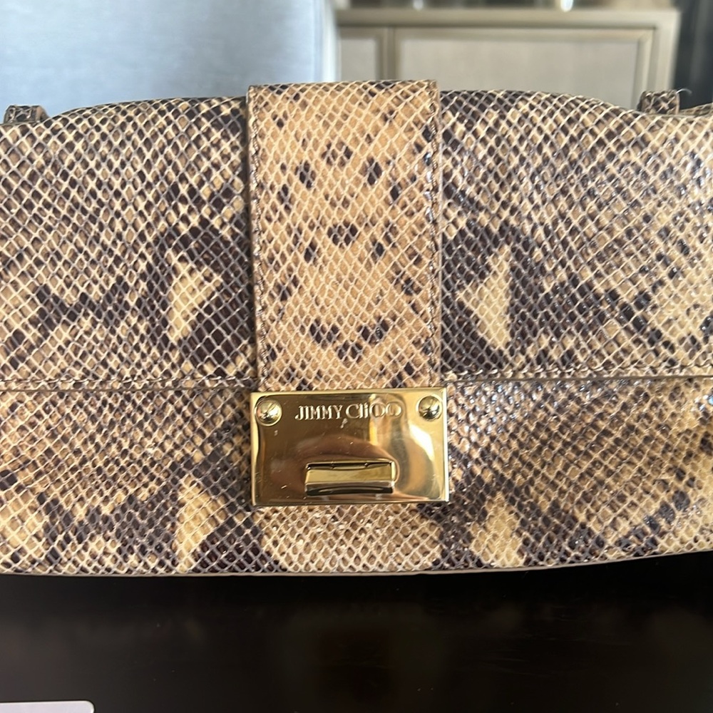 Jimmy Choo skin handbag with gold accents inside pocket cars with authentication